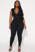 Woman wearing a black jumpsuit on a white background