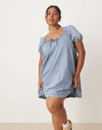 ASOS DESIGN Curve denim mini dress with puff sleeve and tie detail in light wash