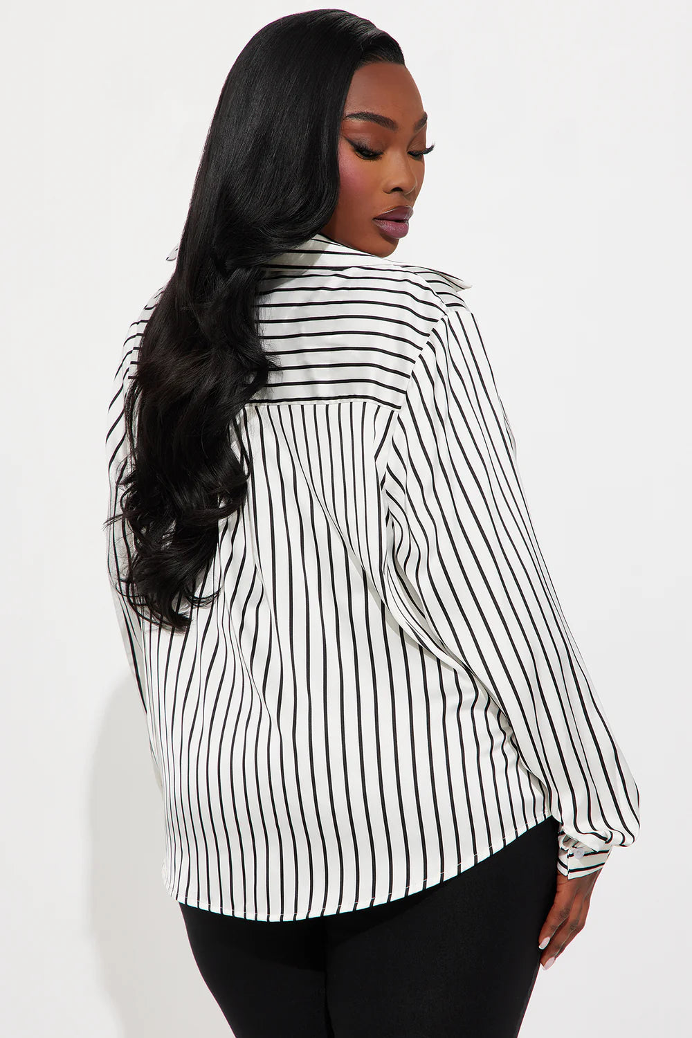 Woman wearing a black and white striped shirt against a white background