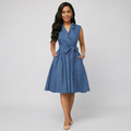 Woman wearing a blue dress with a white background