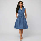 Woman wearing a blue dress with a white background