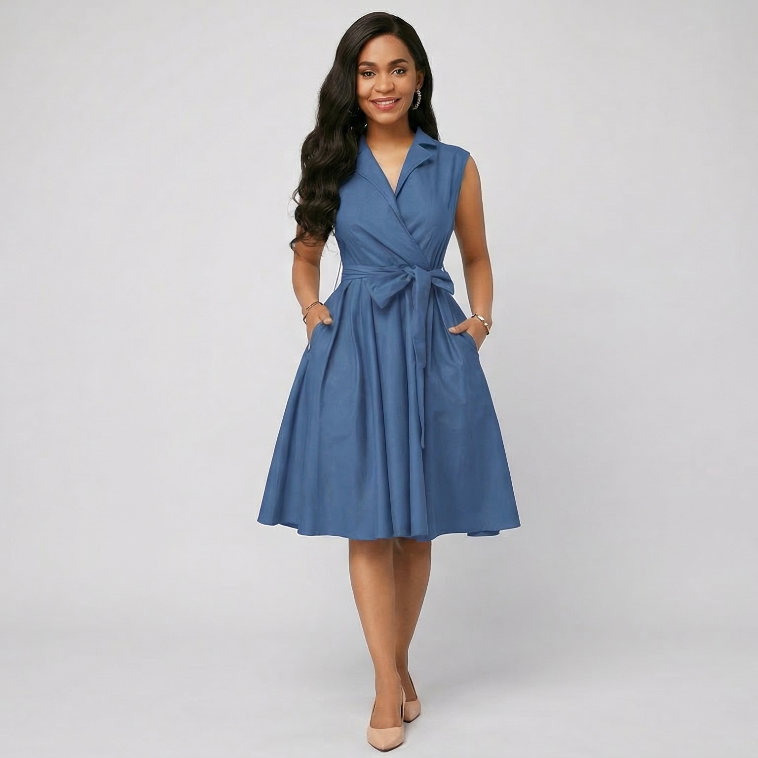 Woman wearing a blue dress with a white background