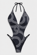 Flat lay of Halter Fishnet Cutout Swimsuit - Black and White on a light grey background